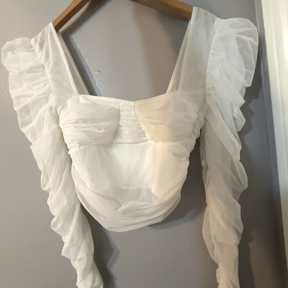 Two puff sleeve crop tops one is in white the other is in lilac